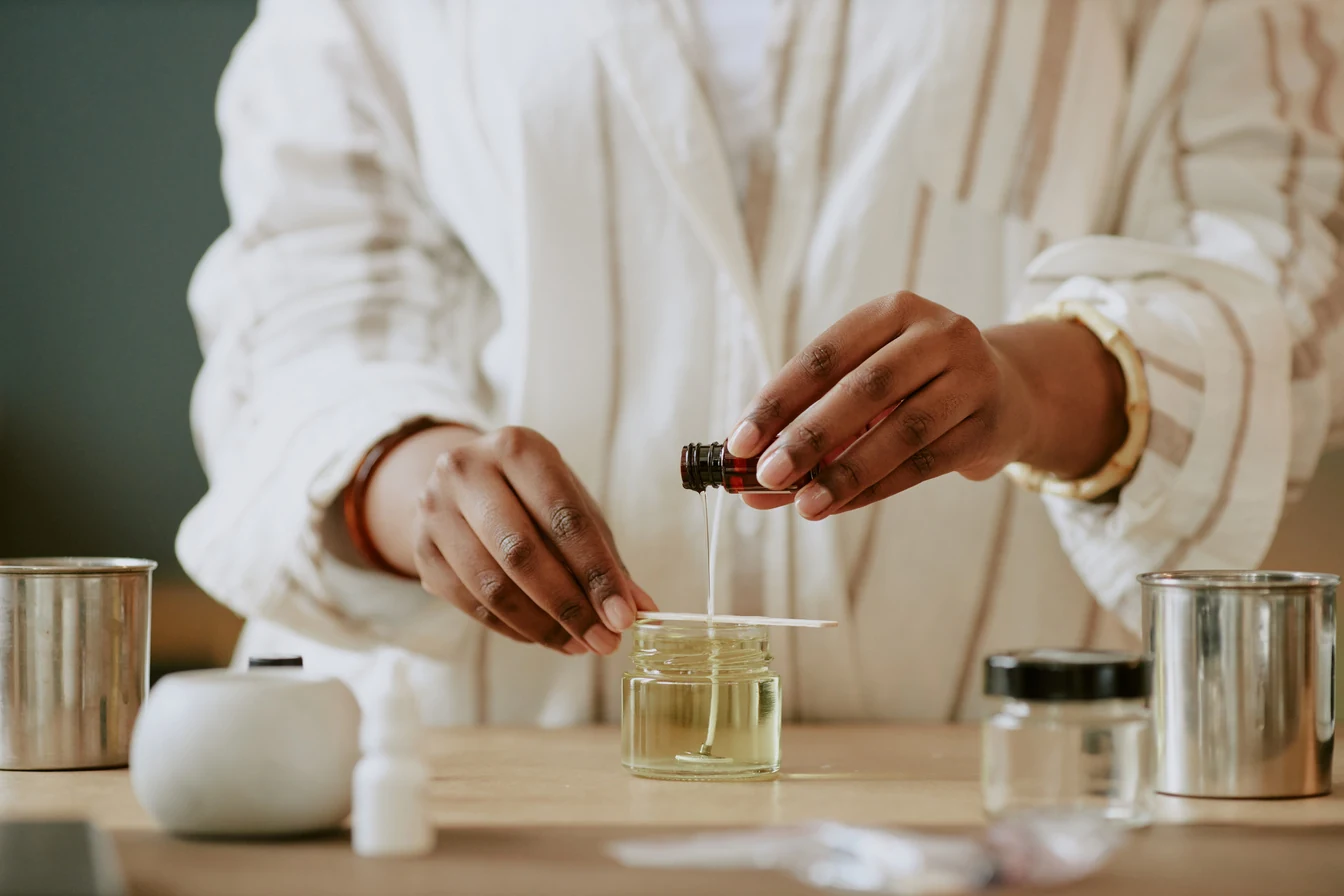 Fragrance sample being evaluated on a scent strip beside laboratory glassware